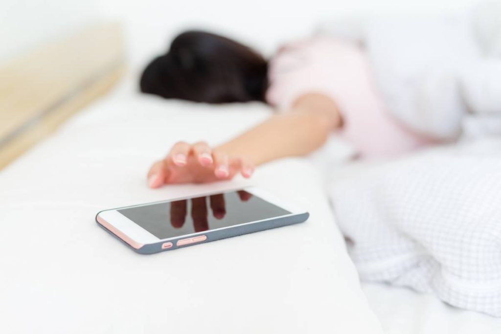 Woman stop the alarm of cellphone